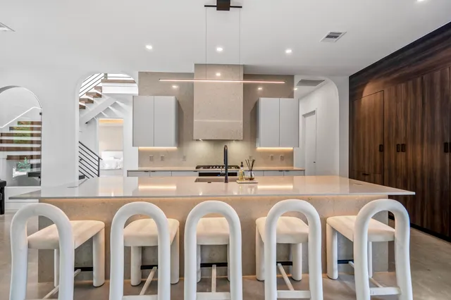 a large kitchen with sink and a large mirror
