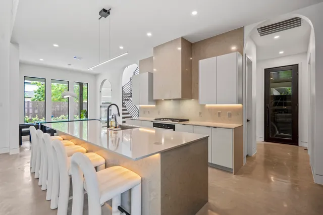a large kitchen with kitchen island a sink appliances and a counter space