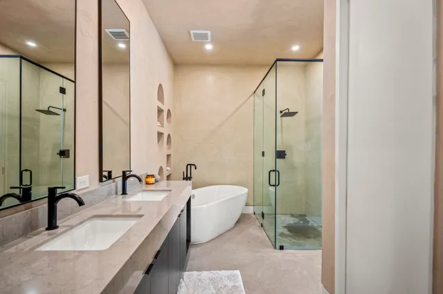 a spacious bathroom with a shower sink and mirror