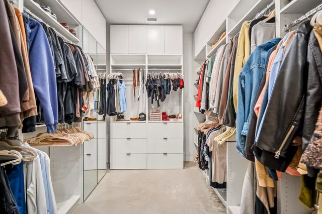 a view of walk in closet with clothes