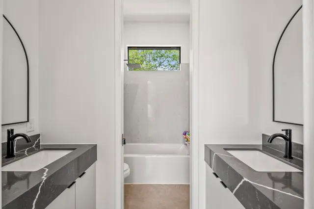 a bedroom with a bed and a potted plant