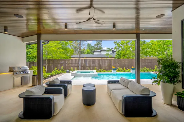 a living room with patio furniture and a flat screen tv