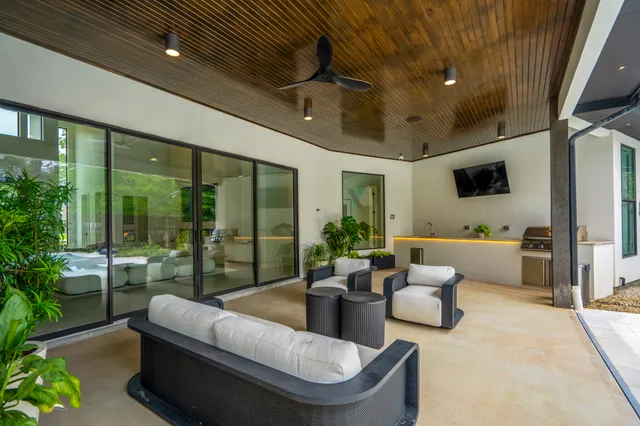 a living room with patio furniture and a wooden floor