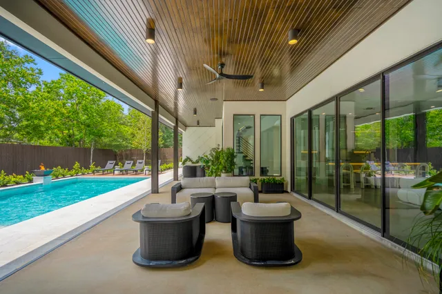 a view of a patio with plants and chairs