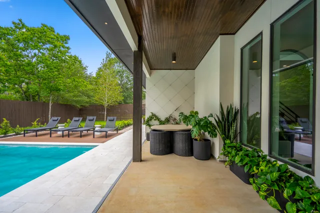 a view of backyard with seating area and green space