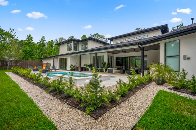 a view of a backyard with sitting area