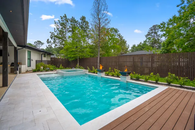 a view of a house with backyard sitting area and garden