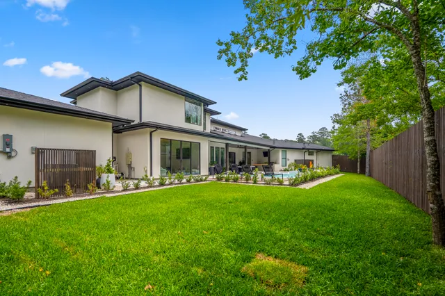 a front view of a house with a yard and outdoor seating