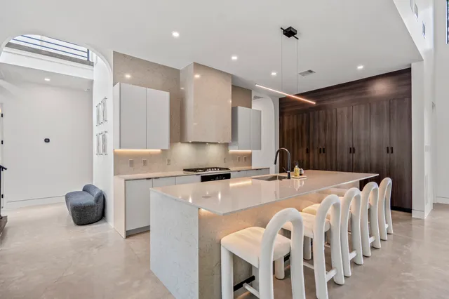 a kitchen with a stove a refrigerator and a table