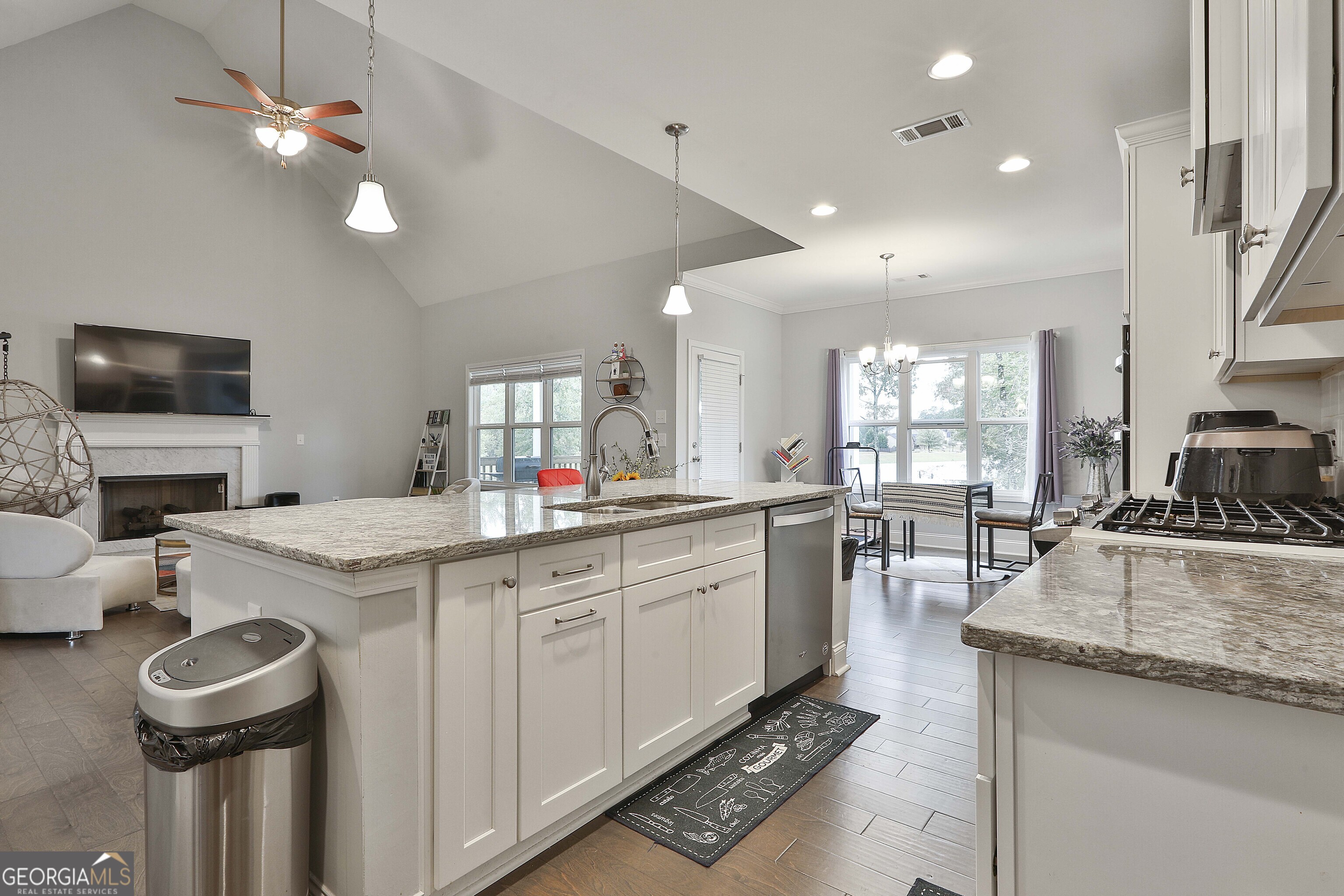 405 Lakeview Way LaGrange, GA 30241 - Photo 14 of 54 a kitchen with a stove a sink a dining table and chairs
