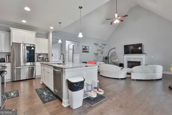 a kitchen with stainless steel appliances kitchen island granite countertop a sink and cabinets