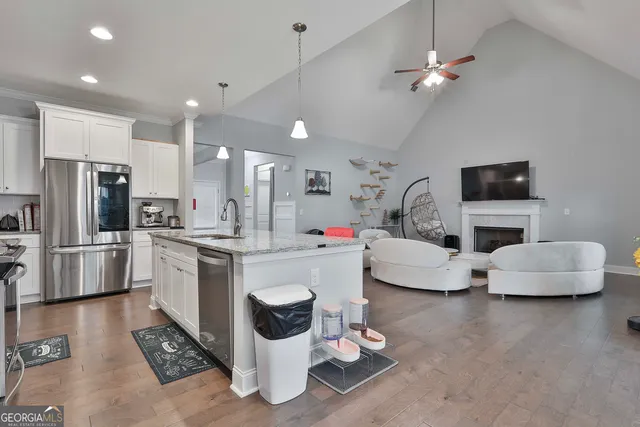 a kitchen with stainless steel appliances kitchen island granite countertop a sink and cabinets