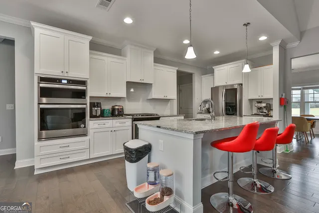 a living room with furniture a dining table and a large window