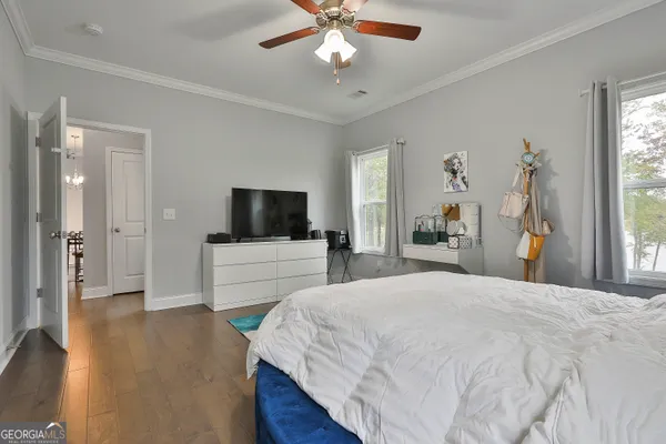 a bathroom with a granite countertop sink a toilet a mirror and shower