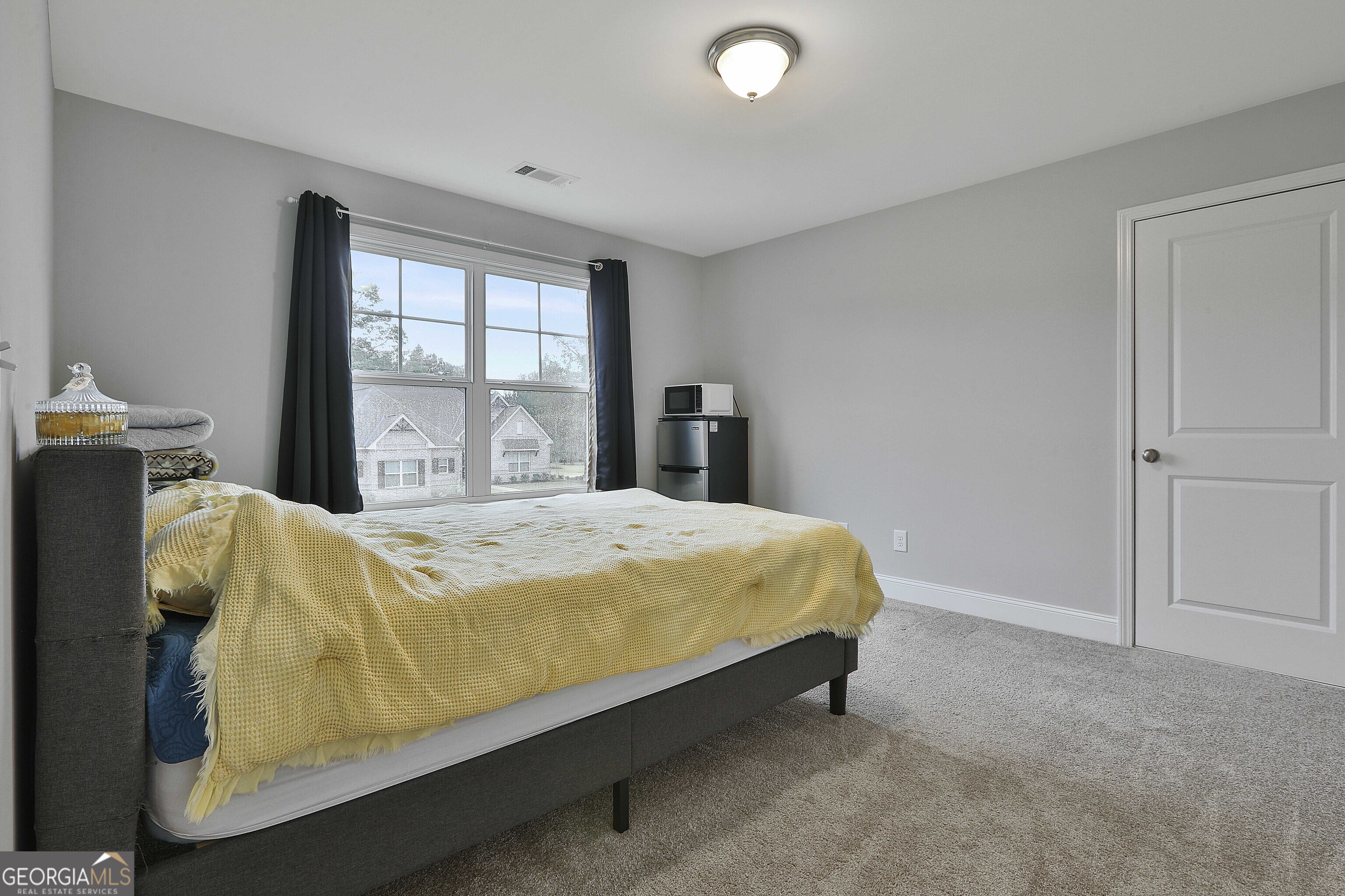 405 Lakeview Way LaGrange, GA 30241 - Photo 27 of 54 a bed sitting in a bedroom next to a window