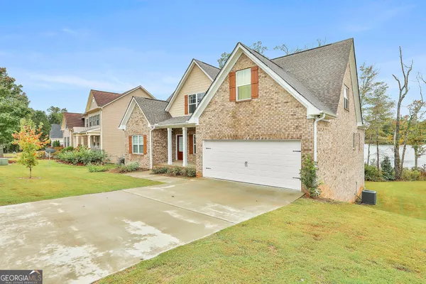 a front view of a house with a yard and garage