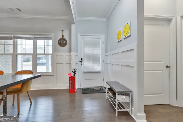 a dining room with furniture a chandelier and wooden floor