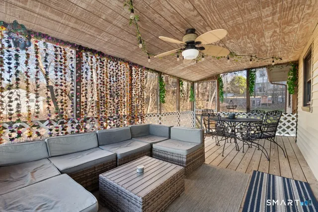 a living room with furniture a table and chairs