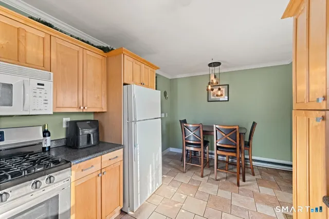 a kitchen with stainless steel appliances granite countertop a refrigerator and a stove top oven