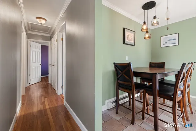 a view of a dining room with furniture and wooden floor