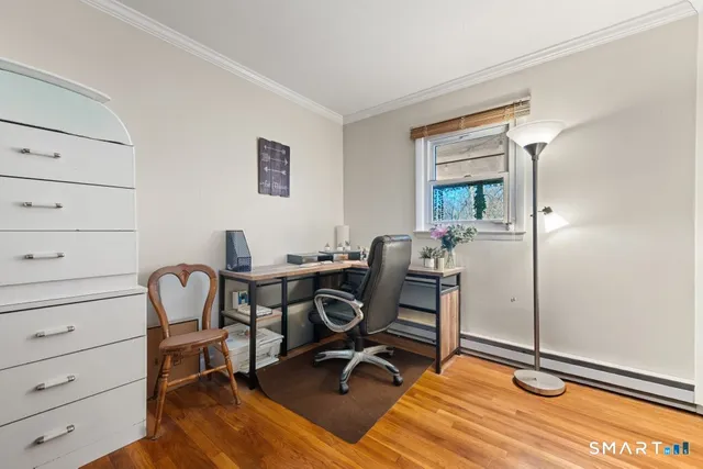 a view of a workspace with furniture and gym equipment