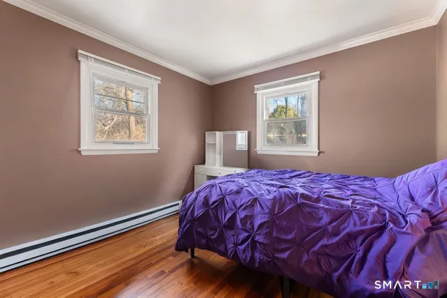 a bed sitting in a bedroom next to a window