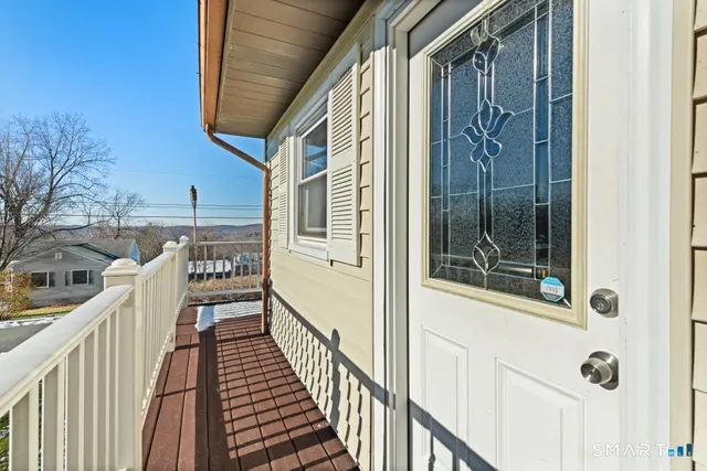 a view of a balcony with wooden floor and stairs