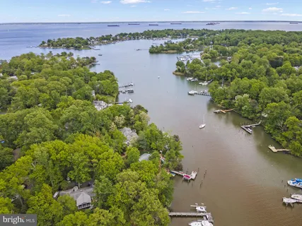 an aerial view of a houses with a lake view