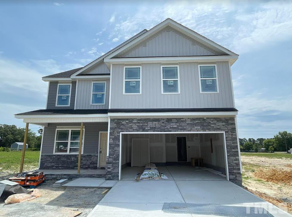 136 Wolf Ridge Willow Spring, NC 27592 - Photo 1 of 3 a front view of a house with a yard and garage