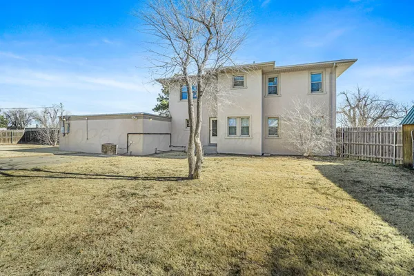 a view of a house with a backyard