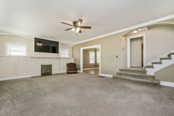 a view of a livingroom with an empty space and a fireplace
