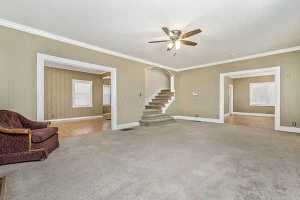 a view of a livingroom with a staircase and white walls