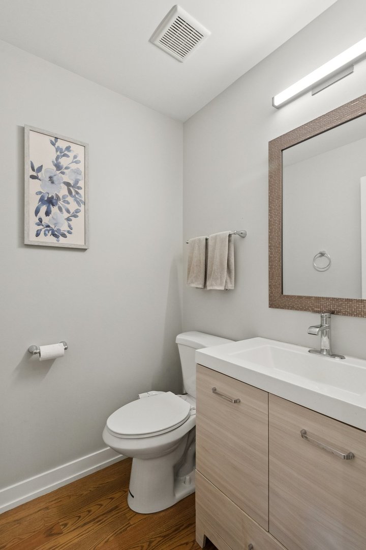 2237 West Coulter Street, Unit 4 Chicago, IL 60608 - Photo 11 of 26 a bathroom with a toilet sink and mirror