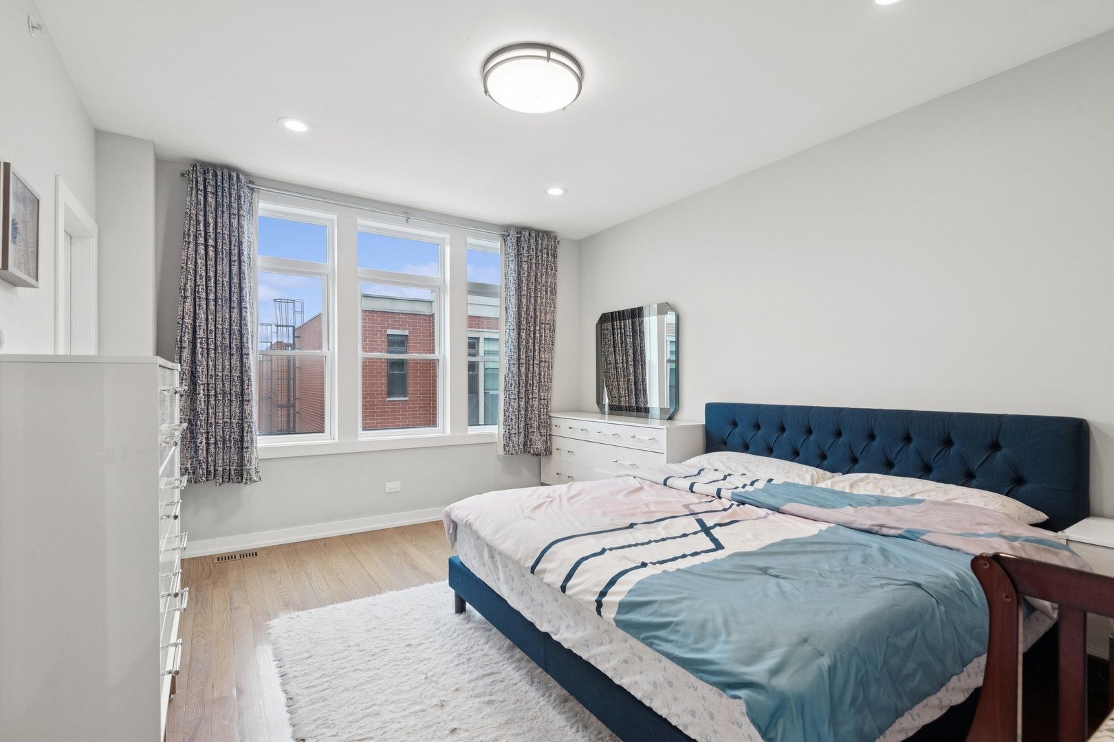 2237 West Coulter Street, Unit 4 Chicago, IL 60608 - Photo 13 of 26 a bedroom with a bed and a large window