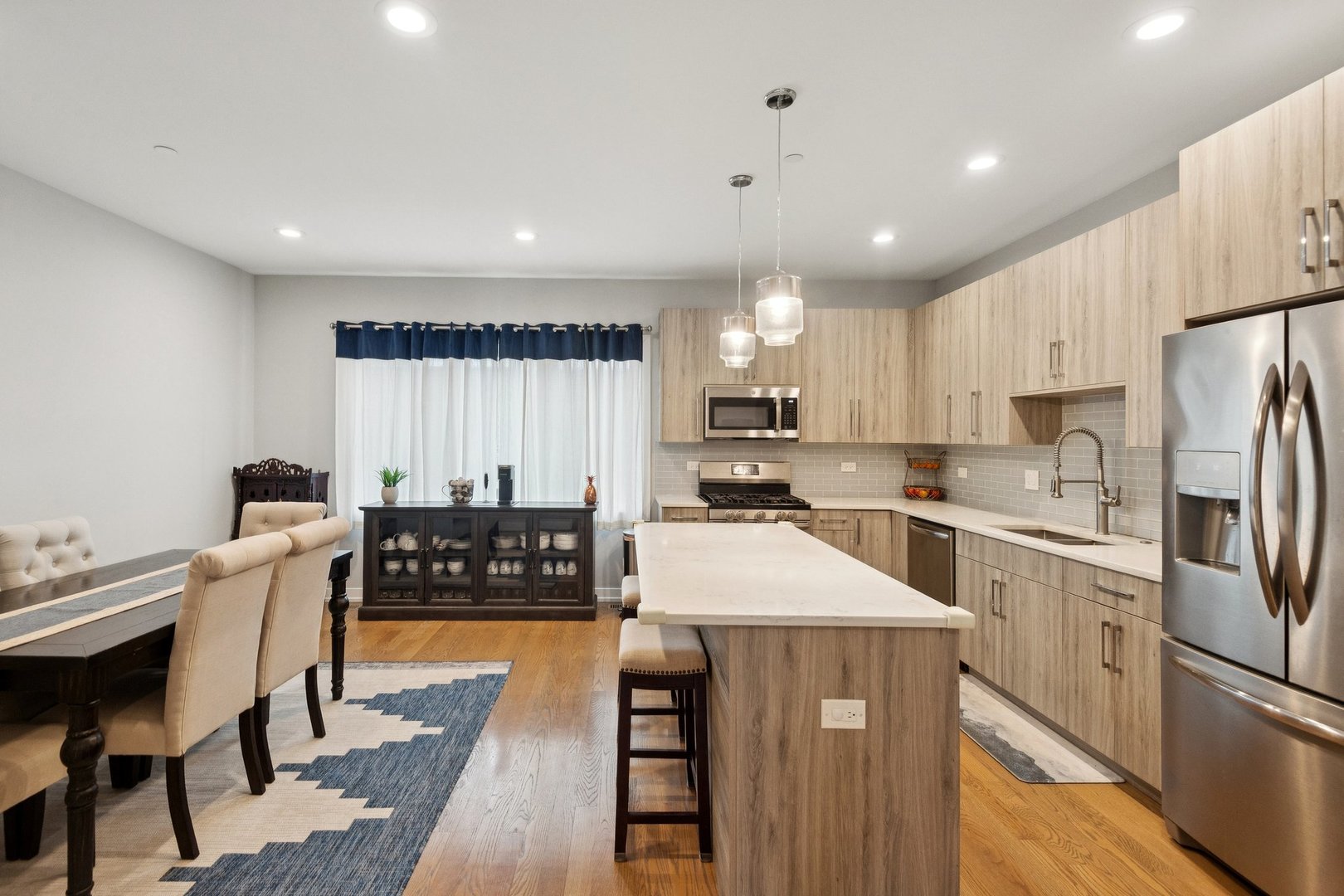 2237 West Coulter Street, Unit 4 Chicago, IL 60608 - Photo 2 of 26 a kitchen with stainless steel appliances granite countertop a refrigerator sink and white cabinets