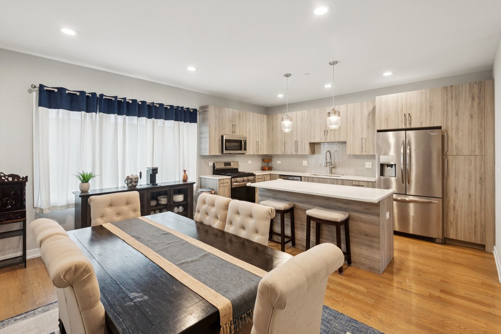 2237 West Coulter Street, Unit 4 Chicago, IL 60608 - Photo 5 of 26 a living room with stainless steel appliances kitchen island granite countertop furniture and a refrigerator