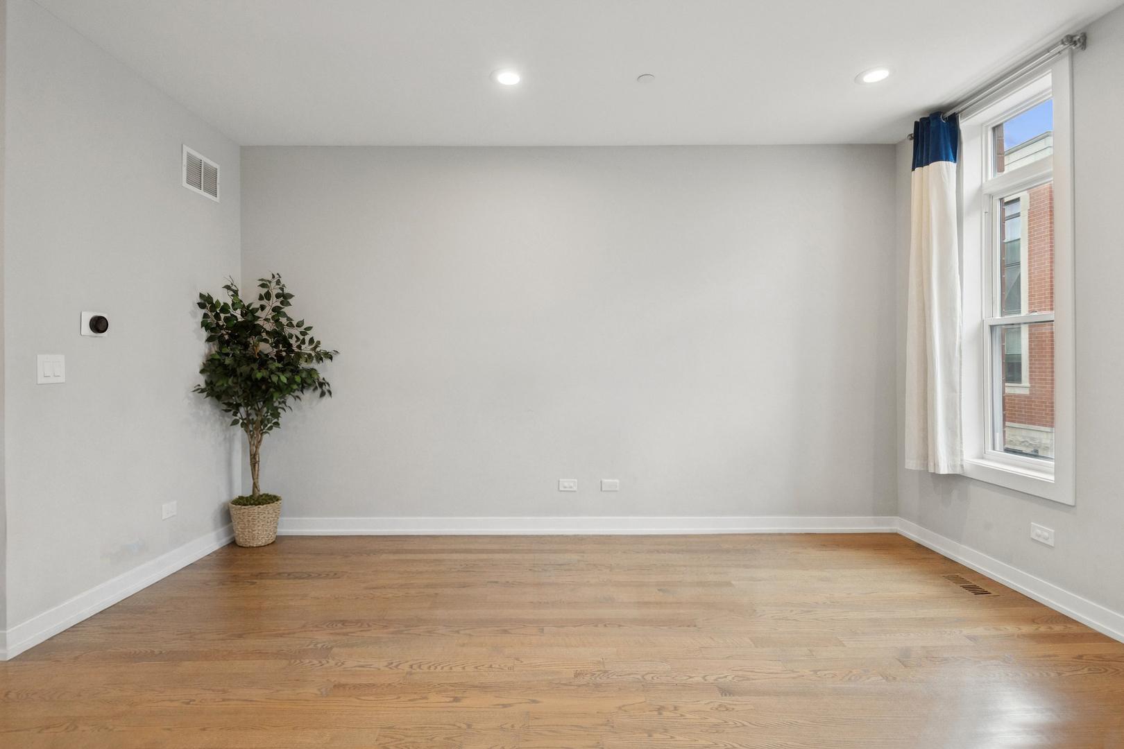 2237 West Coulter Street, Unit 4 Chicago, IL 60608 - Photo 9 of 26 a view of empty room with window and a potted plant