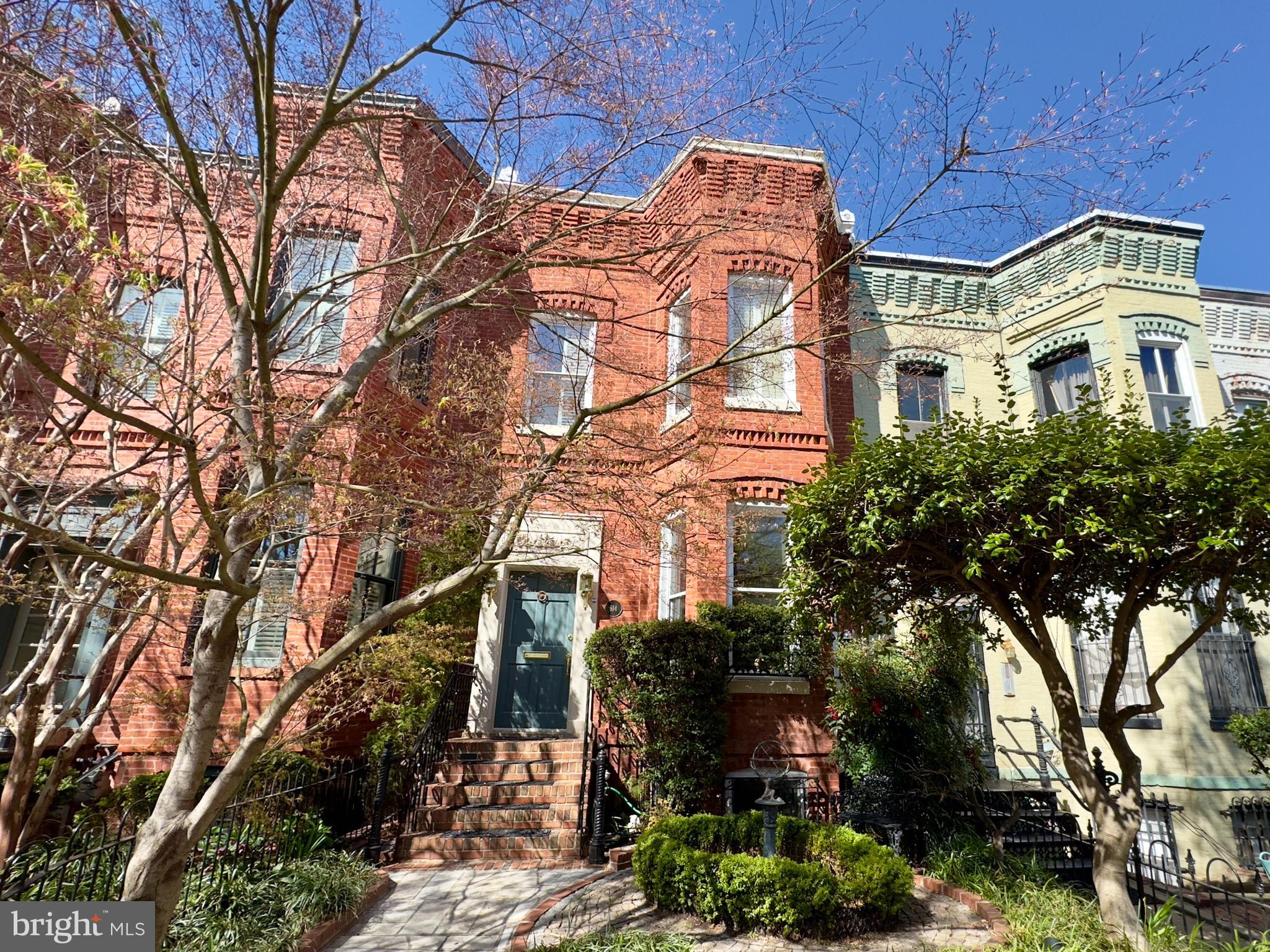a front view of a residential apartment building with a yard
