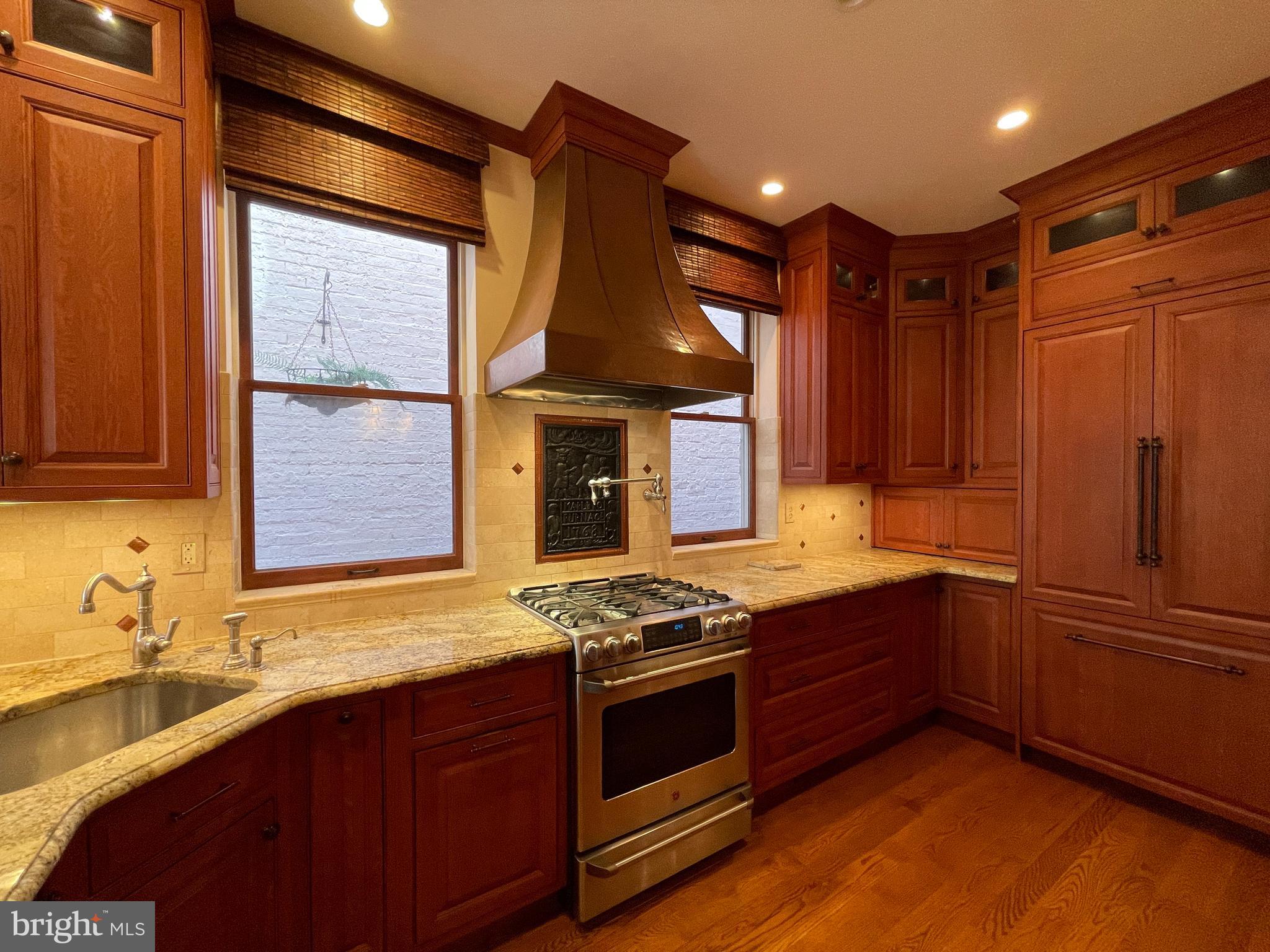 614 A Street Northeast Washington, DC 20002 - Photo 12 of 48 a kitchen with stainless steel appliances granite countertop a sink stove and refrigerator