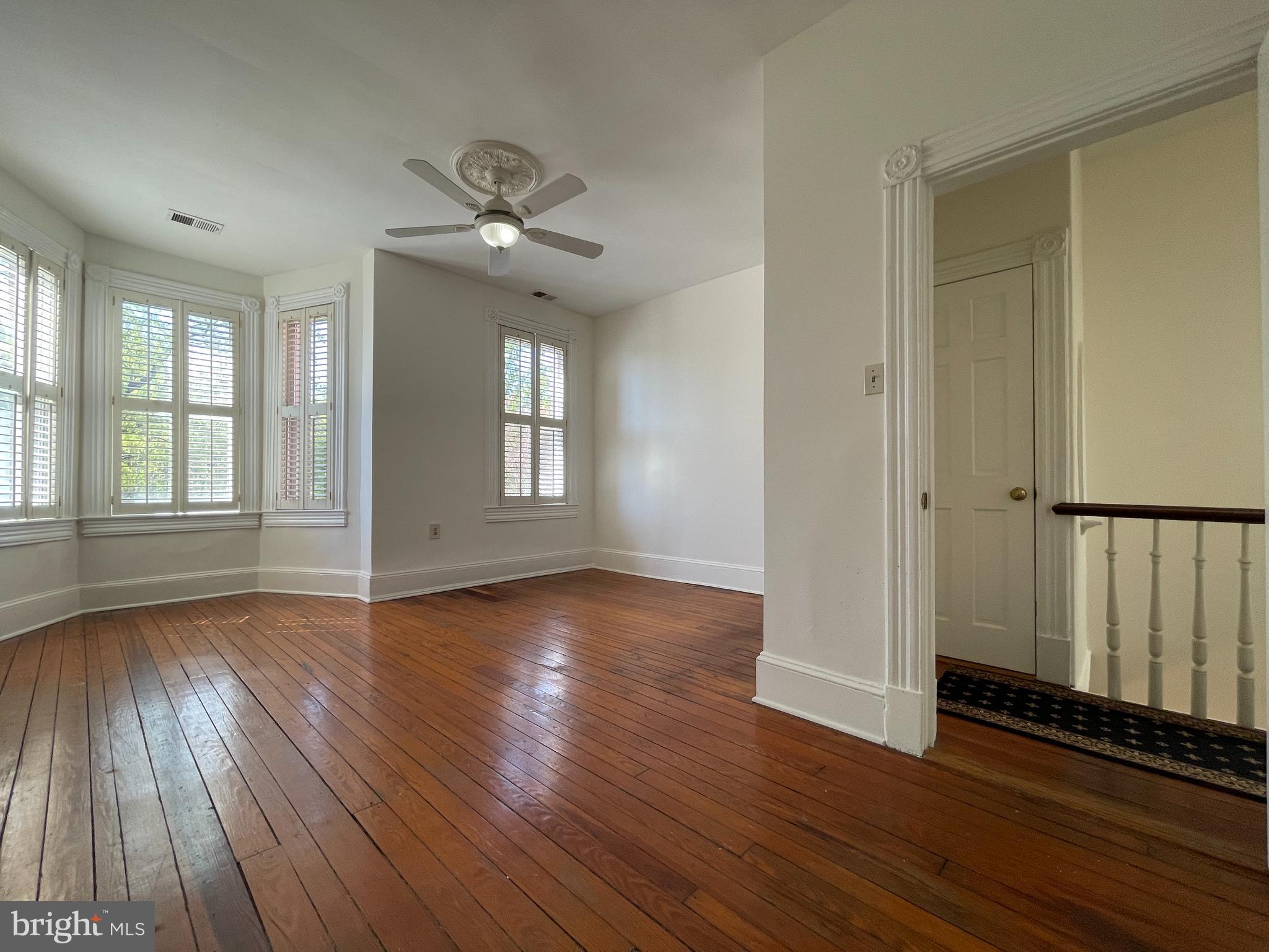 614 A Street Northeast Washington, DC 20002 - Photo 20 of 48 an empty room with wooden floor fan and windows