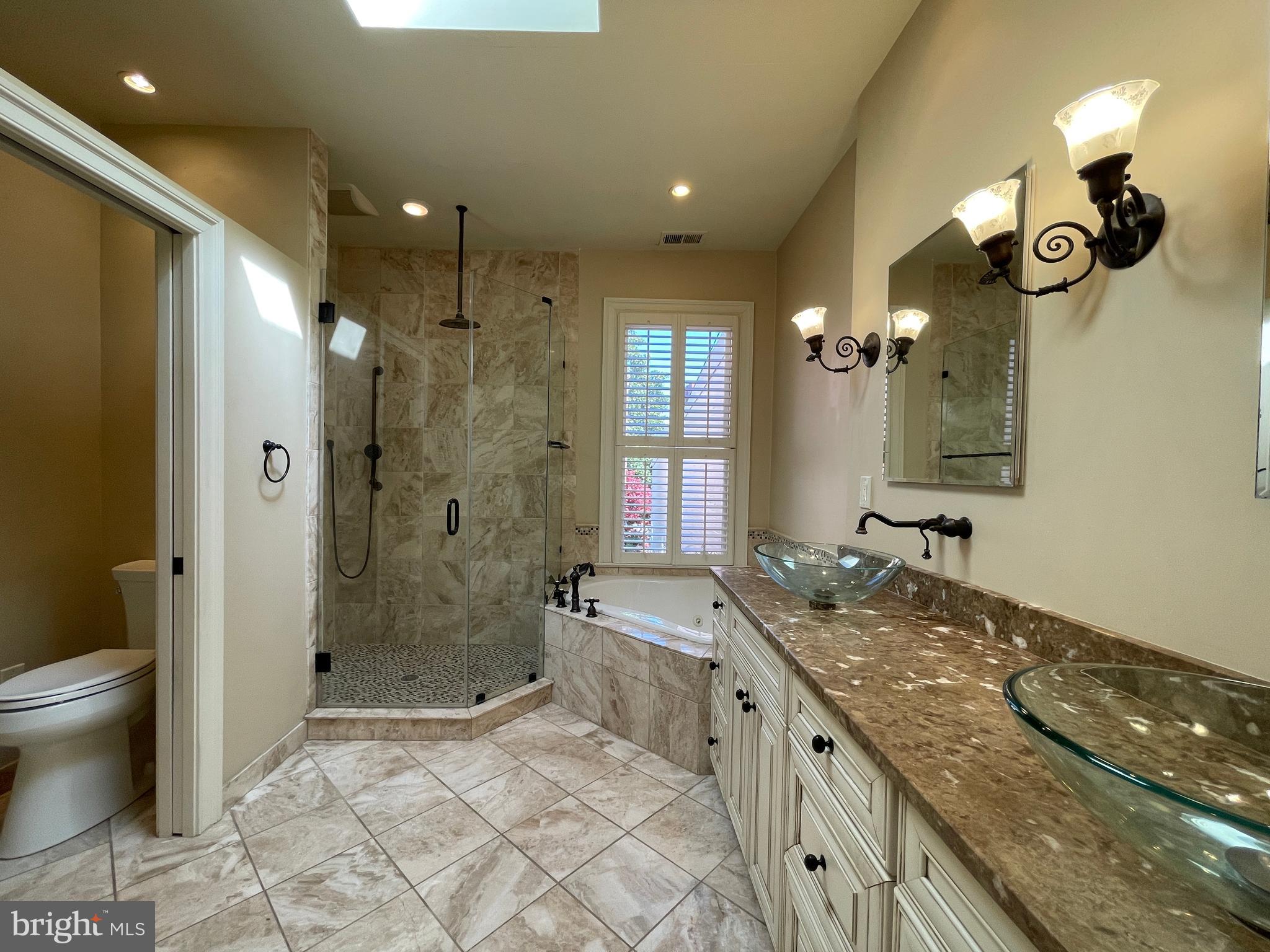 614 A Street Northeast Washington, DC 20002 - Photo 25 of 48 a spacious bathroom with a granite countertop sink a toilet a mirror and shower