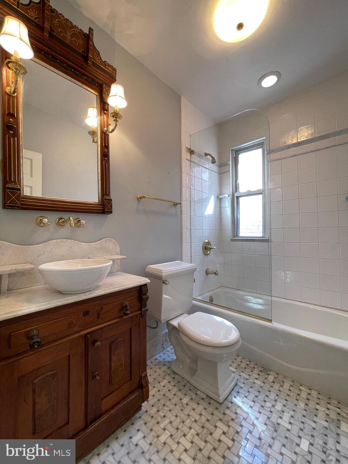 614 A Street Northeast Washington, DC 20002 - Photo 26 of 48 a bathroom with a sink a toilet and mirror