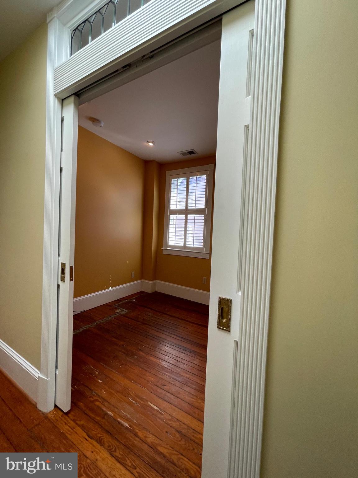 614 A Street Northeast Washington, DC 20002 - Photo 27 of 48 a view of an empty room with wooden floor and a window