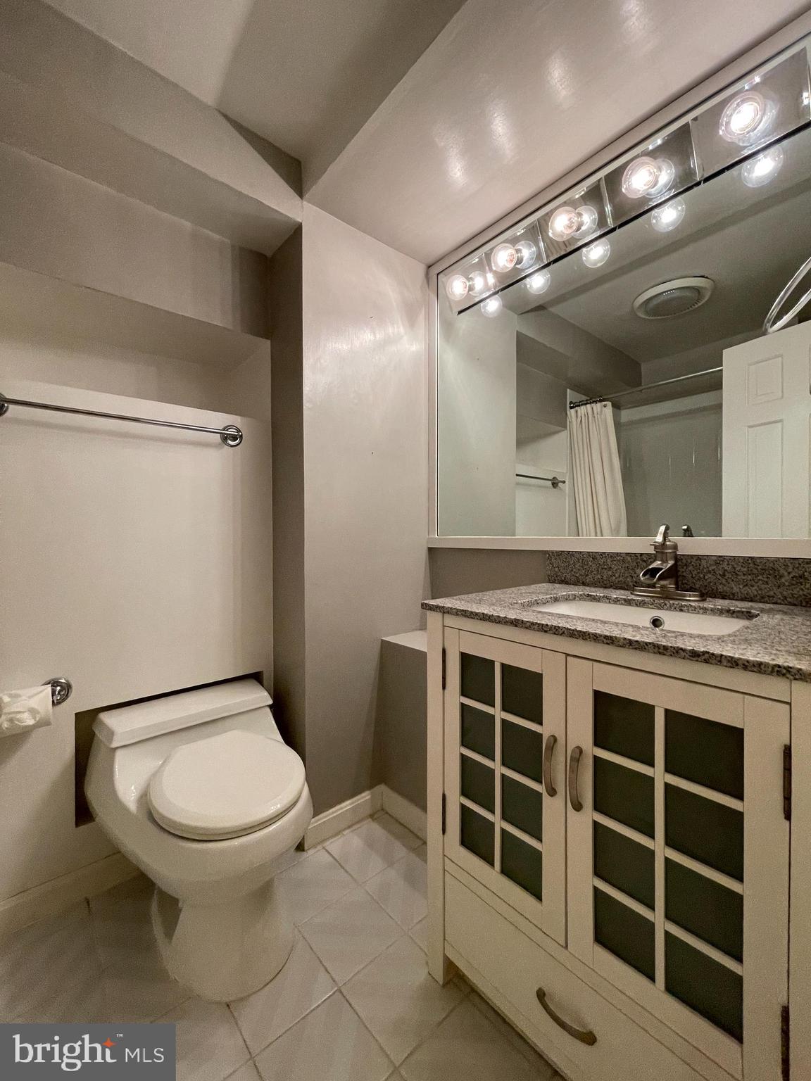 614 A Street Northeast Washington, DC 20002 - Photo 36 of 48 a bathroom with a toilet a sink and mirror