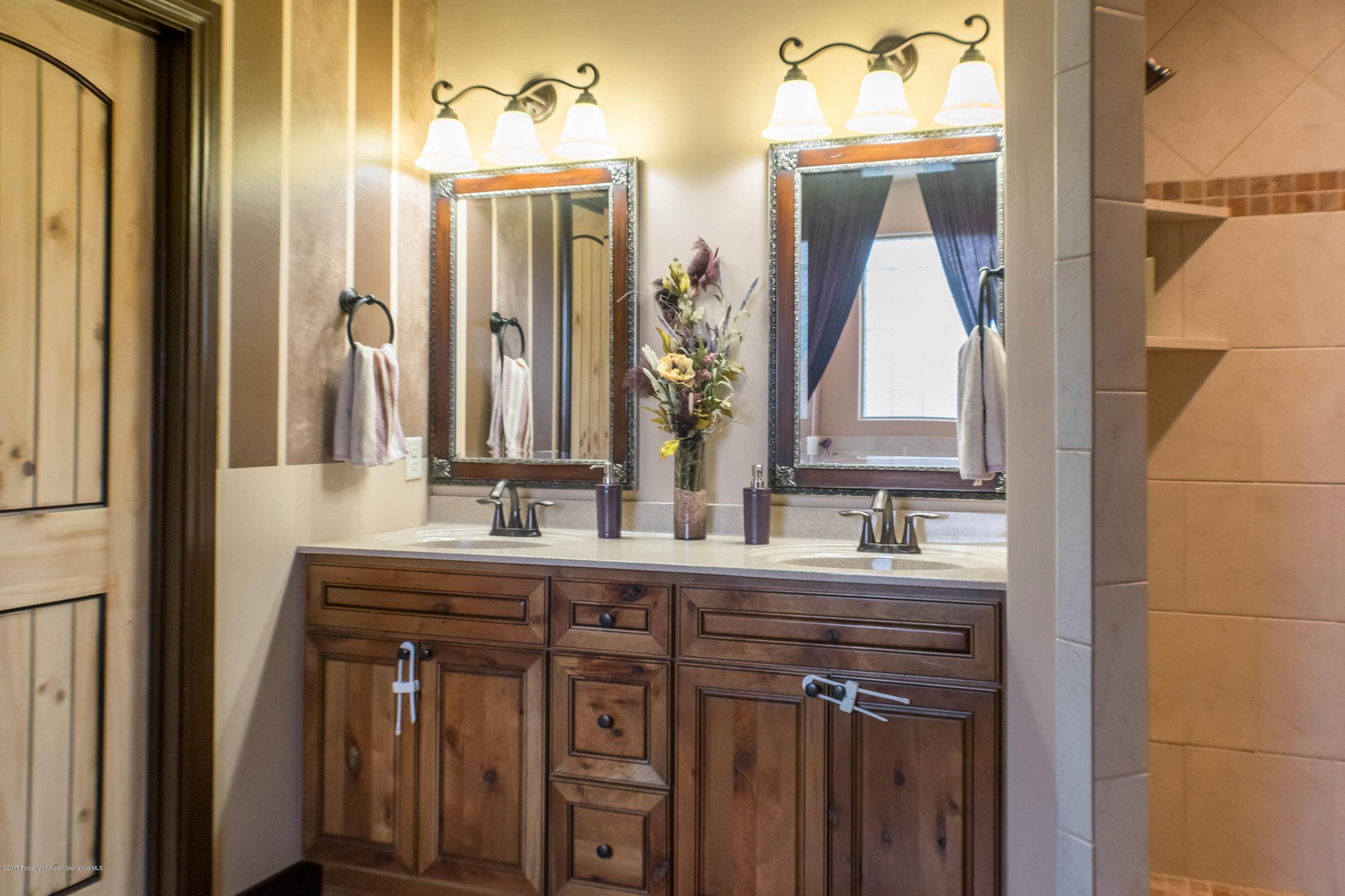 1690 8 Road Mack, CO 81525 - Photo 20 of 37 a bathroom with a double vanity sink and a mirror