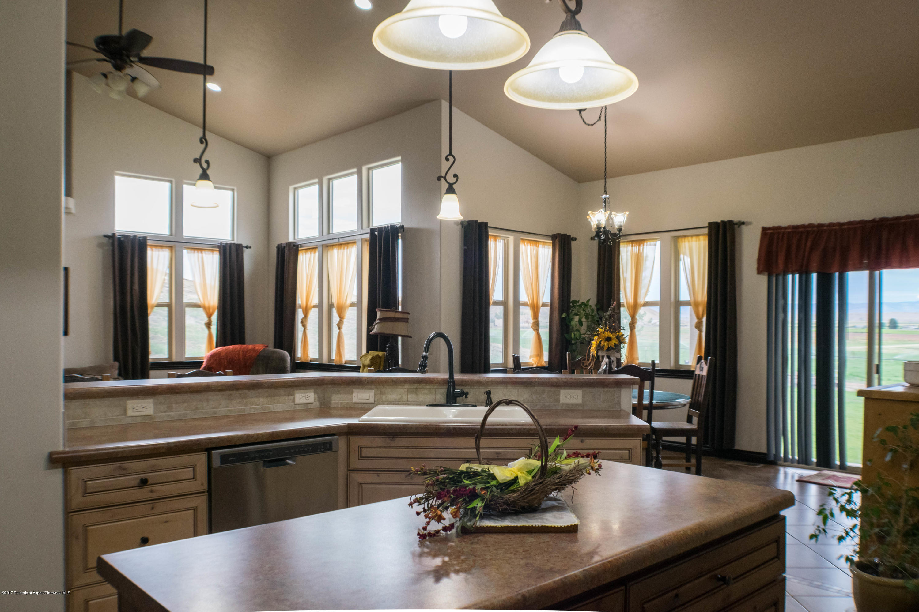 1690 8 Road Mack, CO 81525 - Photo 8 of 37 a kitchen with living room and chandelier