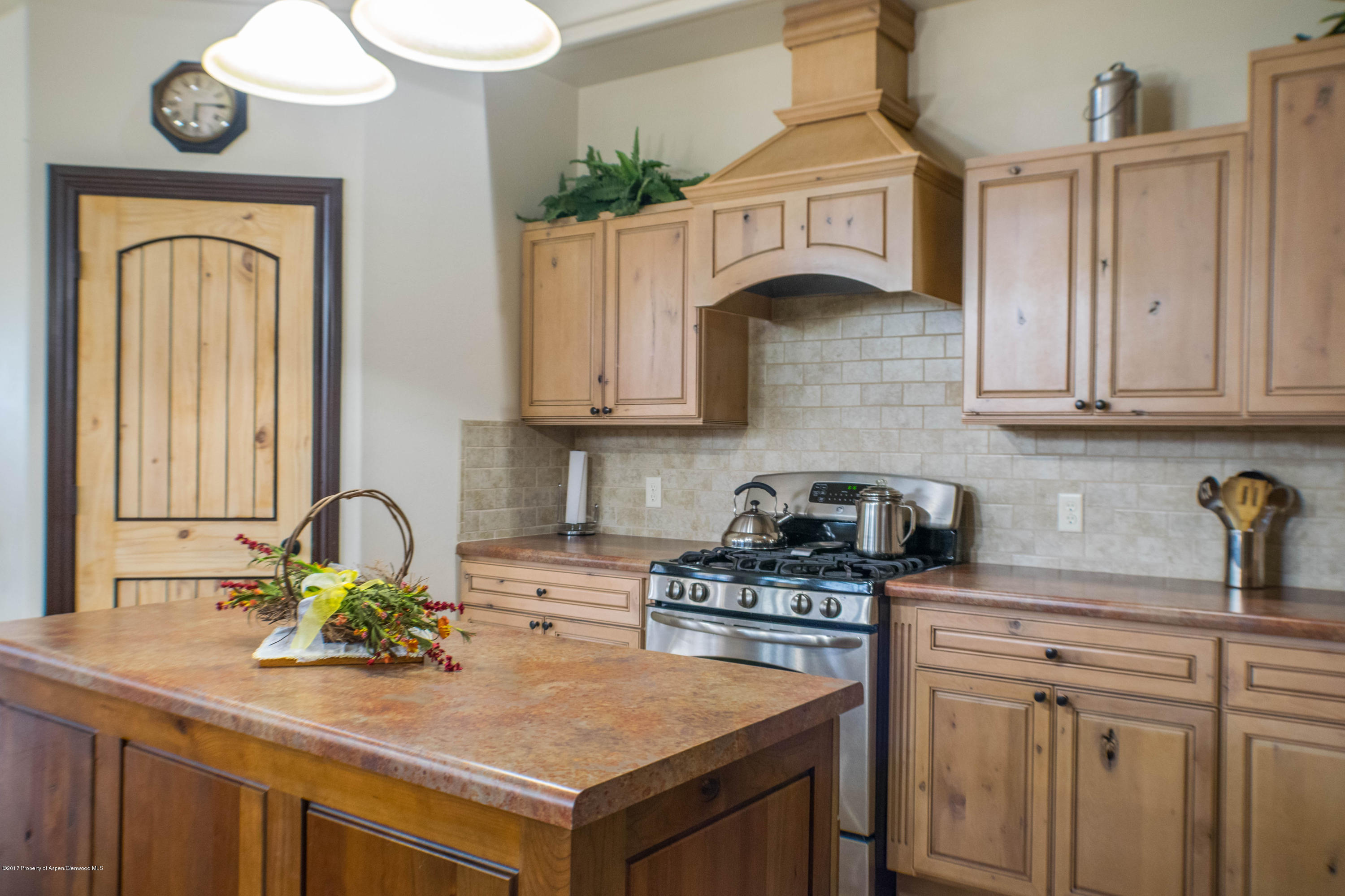 1690 8 Road Mack, CO 81525 - Photo 10 of 37 a kitchen with stainless steel appliances granite countertop a stove a sink and cabinets