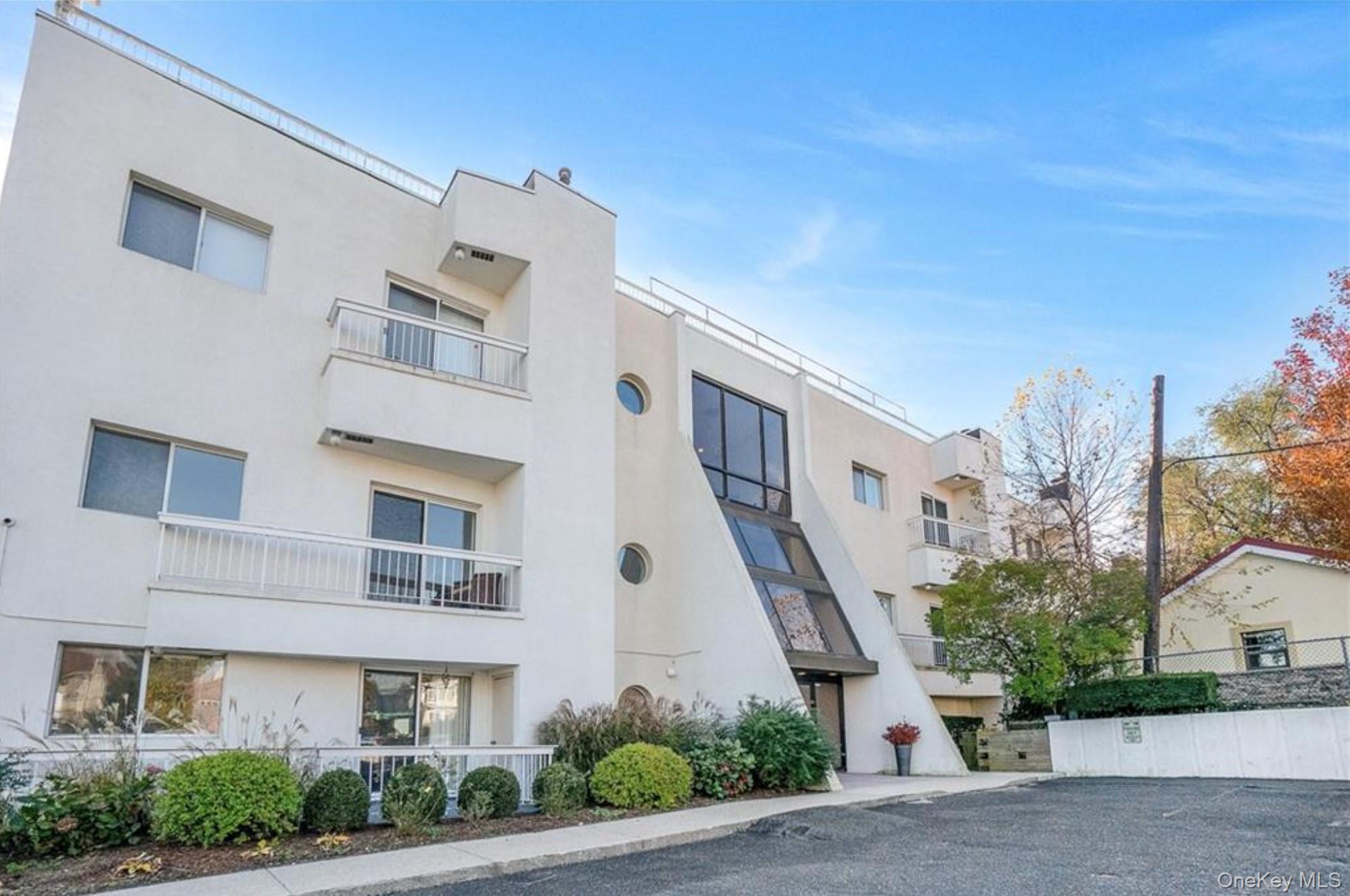 190 Schofield Street, Unit 2E Bronx, NY 10464 - Photo 1 of 24 a front view of a building with garden