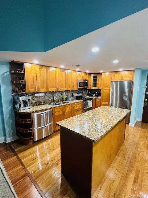 190 Schofield Street, Unit 2E Bronx, NY 10464 - Photo 12 of 24 a kitchen with stainless steel appliances granite countertop a sink stove and cabinets