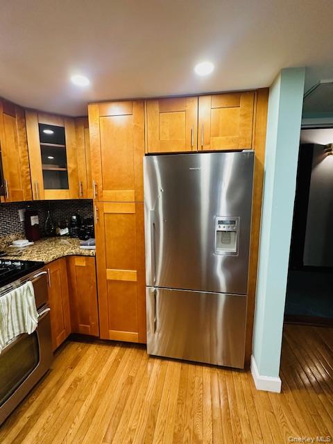 190 Schofield Street, Unit 2E Bronx, NY 10464 - Photo 14 of 24 a view of a kitchen with wooden floor and stainless steel appliances